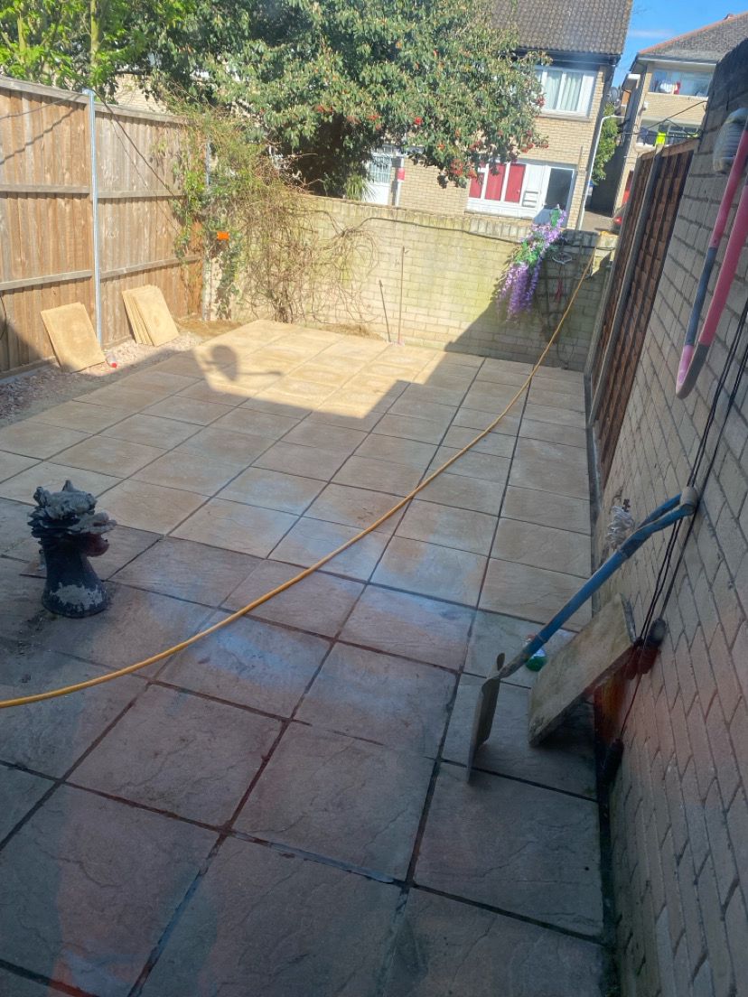 Mixed tone large format patio slabs laid in garden